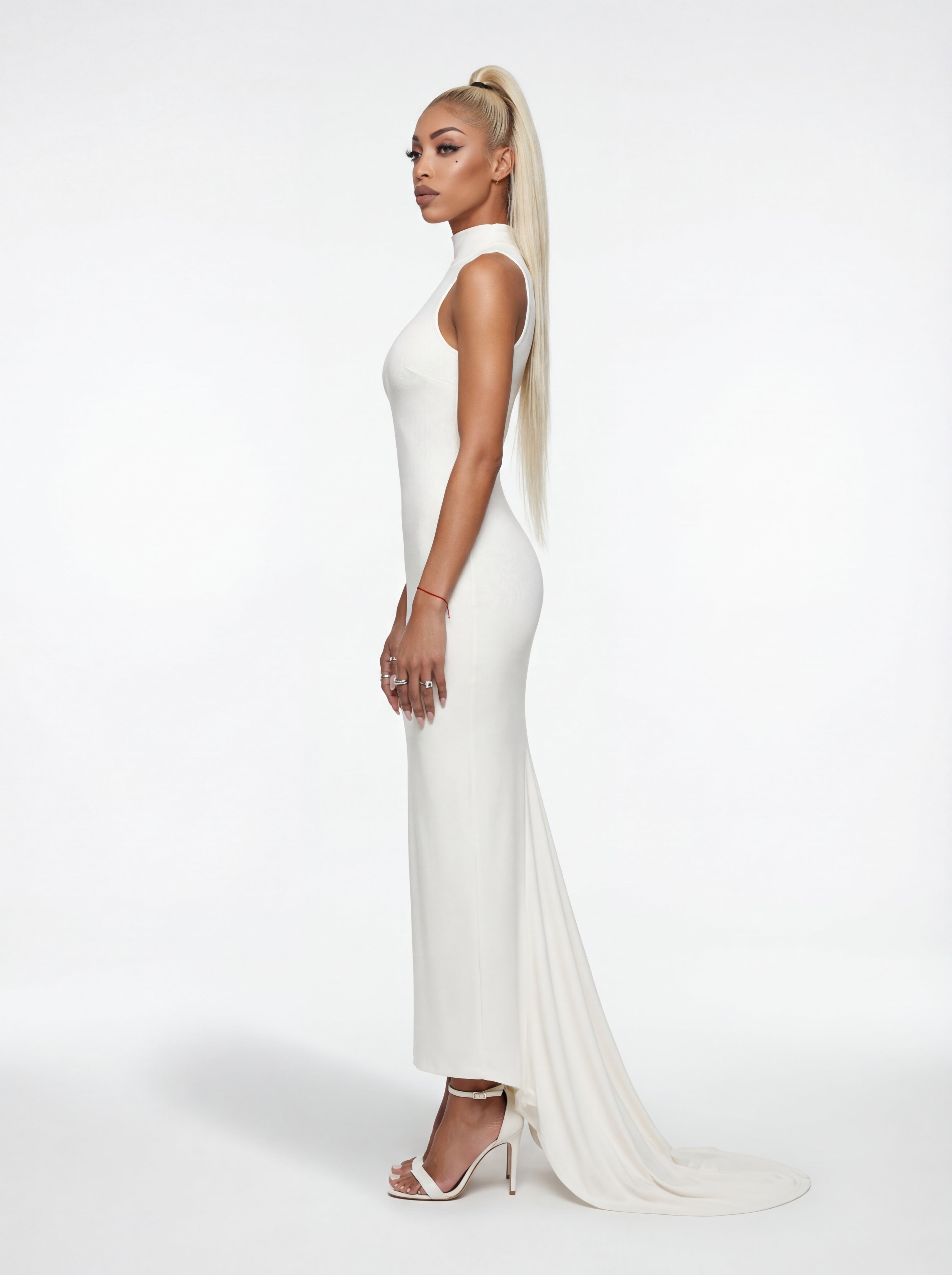 Woman in a white evening gown with a long train on a white background