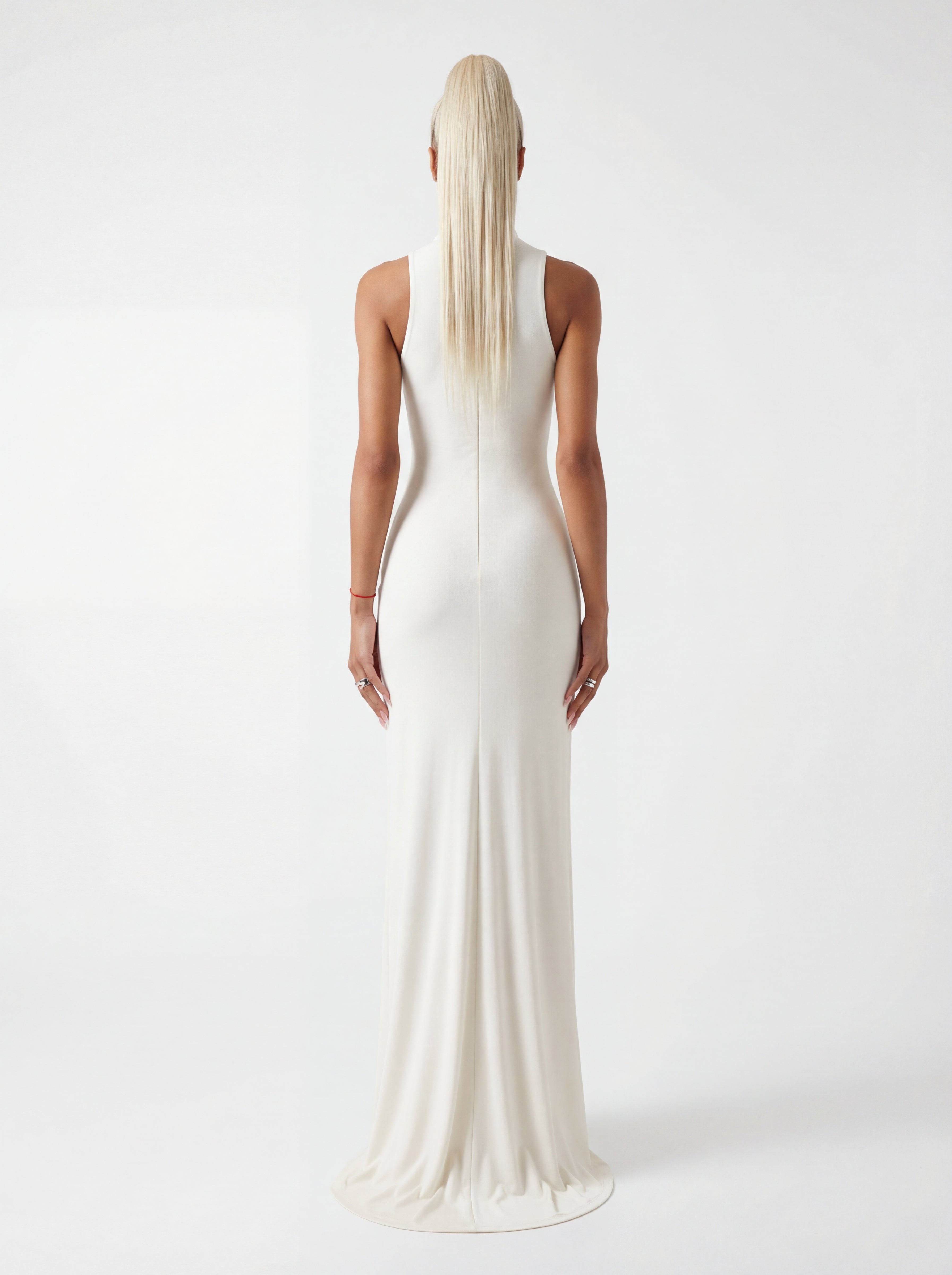 Woman wearing a white evening gown on a plain background