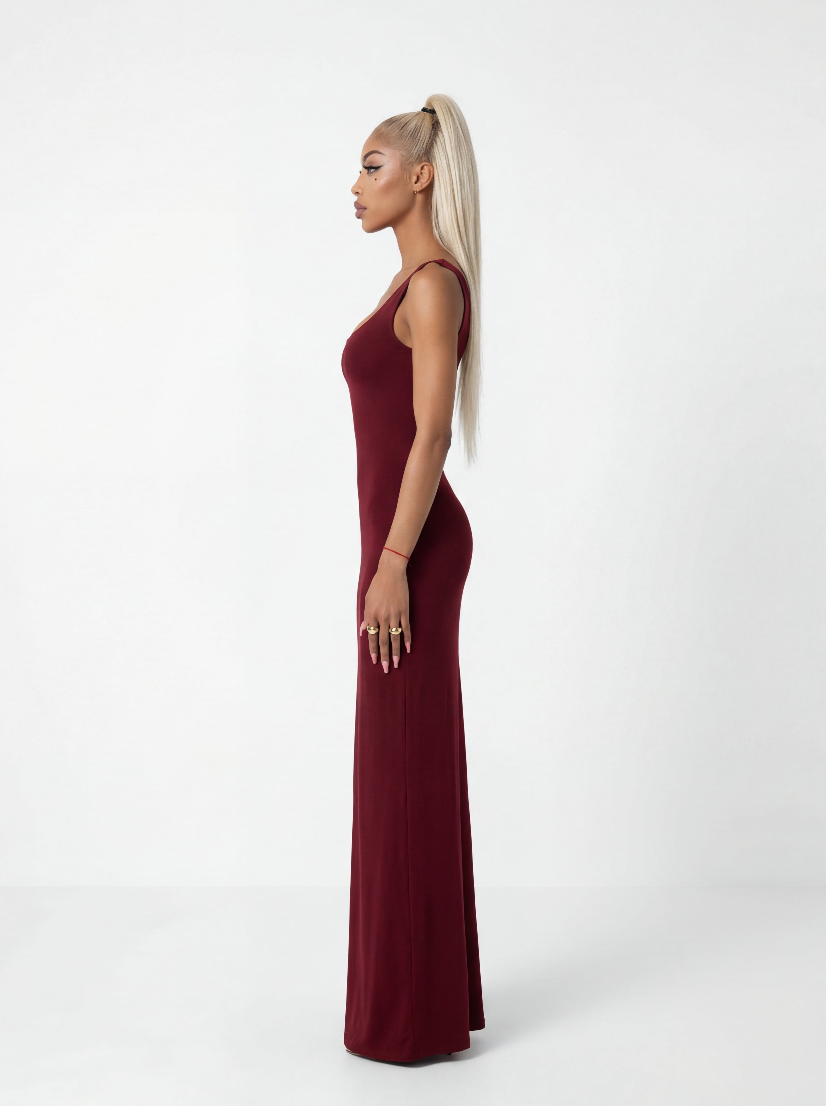 Woman wearing a burgundy dress on a white background